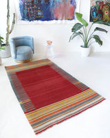 Vintage kilim rug in living room setting, bright colors, wild shaman, soft rug, bold color, Portland, Oregon, rug store, rug shop, local shop, vintage rug, modern kilim, warm colors, antique rug, antique kilim