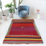Vintage kilim rug in living room setting, bright colors, wild shaman, soft rug, bold color, Portland, Oregon, rug store, rug shop, local shop, vintage rug, modern kilim, warm colors, antique rug, antique kilim