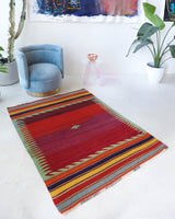 Vintage kilim rug in living room setting, bright colors, wild shaman, soft rug, bold color, Portland, Oregon, rug store, rug shop, local shop, vintage rug, modern kilim, warm colors, antique rug, antique kilim