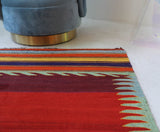 Vintage kilim rug in living room setting, bright colors, wild shaman, soft rug, bold color, Portland, Oregon, rug store, rug shop, local shop, vintage rug, modern kilim, warm colors, antique rug, antique kilim