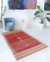 Vintage kilim rug in living room setting, old rug, antique rug, pastel colors, faded colors, Turkish rug, vintage rug, soft rug, Portland, Oregon, rug store, rug shop, local shop, earthy tones, earthy colors, warm colors