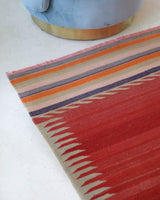 Vintage kilim rug in living room setting, old rug, antique rug, pastel colors, faded colors, Turkish rug, vintage rug, soft rug, Portland, Oregon, rug store, rug shop, local shop, earthy tones, earthy colors, warm colors