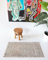Vintage Turkish mini rug in room decor setting, old rug, antique rug, pastel colors, faded colors, Turkish rug, vintage rug, soft rug, Portland, Oregon, rug store, rug shop, local shop,  bright colors, bold colors
