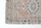 Vintage Turkish mini rug in room decor setting, old rug, antique rug, pastel colors, faded colors, Turkish rug, vintage rug, soft rug, Portland, Oregon, rug store, rug shop, local shop,  bright colors, bold colors