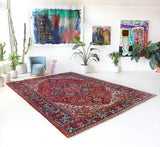 Antique Persian area rug in a living room setting, pile rug, vintage rug, portland, rug shop, bright colors, wild shaman, soft rug, bold color, Portland, Oregon, rug store, rug shop, local shop, antique rug, Persian rug, handmade rug, wool rug, distressed rug