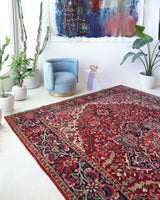 Antique Persian area rug in a living room setting, pile rug, vintage rug, portland, rug shop, bright colors, wild shaman, soft rug, bold color, Portland, Oregon, rug store, rug shop, local shop, antique rug, Persian rug, handmade rug, wool rug, distressed rug
