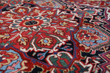 Antique Persian area rug in a living room setting, pile rug, vintage rug, portland, rug shop, bright colors, wild shaman, soft rug, bold color, Portland, Oregon, rug store, rug shop, local shop, antique rug, Persian rug, handmade rug, wool rug, distressed rug