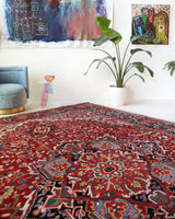 Antique Persian area rug in a living room setting, pile rug, vintage rug, portland, rug shop, bright colors, wild shaman, soft rug, bold color, Portland, Oregon, rug store, rug shop, local shop, antique rug, Persian rug, handmade rug, wool rug, distressed rug