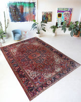 Antique Persian area rug in a living room setting, pile rug, vintage rug, portland, rug shop, bright colors, wild shaman, soft rug, bold color, Portland, Oregon, rug store, rug shop, local shop, antique rug, Persian rug, handmade rug, wool rug, distressed rug