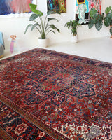 Antique Persian area rug in a living room setting, pile rug, vintage rug, portland, rug shop, bright colors, wild shaman, soft rug, bold color, Portland, Oregon, rug store, rug shop, local shop, antique rug, Persian rug, handmade rug, wool rug, distressed rug
