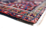 Antique Persian area rug in a living room setting, pile rug, vintage rug, portland, rug shop, bright colors, wild shaman, soft rug, bold color, Portland, Oregon, rug store, rug shop, local shop, antique rug, Persian rug, handmade rug, wool rug, distressed rug
