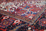Antique Persian area rug in a living room setting, pile rug, vintage rug, portland, rug shop, bright colors, wild shaman, soft rug, bold color, Portland, Oregon, rug store, rug shop, local shop, antique rug, Persian rug, handmade rug, wool rug, distressed rug