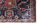 Antique Persian area rug in a living room setting, pile rug, vintage rug, portland, rug shop, bright colors, wild shaman, soft rug, bold color, Portland, Oregon, rug store, rug shop, local shop, antique rug, Persian rug, handmade rug, wool rug, distressed rug