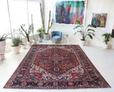 Antique Persian area rug in a living room setting, pile rug, vintage rug, portland, rug shop, bright colors, wild shaman, soft rug, bold color, Portland, Oregon, rug store, rug shop, local shop, antique rug, Persian rug, handmade rug, wool rug, distressed rug