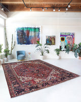 Antique Persian area rug in a living room setting, pile rug, vintage rug, portland, rug shop, bright colors, wild shaman, soft rug, bold color, Portland, Oregon, rug store, rug shop, local shop, antique rug, Persian rug, handmade rug, wool rug, distressed rug