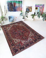 Antique Persian area rug in a living room setting, pile rug, vintage rug, portland, rug shop, bright colors, wild shaman, soft rug, bold color, Portland, Oregon, rug store, rug shop, local shop, antique rug, Persian rug, handmade rug, wool rug, distressed rug