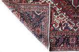 Antique Persian area rug in a living room setting, pile rug, vintage rug, portland, rug shop, bright colors, wild shaman, soft rug, bold color, Portland, Oregon, rug store, rug shop, local shop, antique rug, Persian rug, handmade rug, wool rug, distressed rug