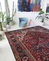 Antique Persian area rug in a living room setting, pile rug, vintage rug, portland, rug shop, bright colors, wild shaman, soft rug, bold color, Portland, Oregon, rug store, rug shop, local shop, antique rug, Persian rug, handmade rug, wool rug, distressed rug