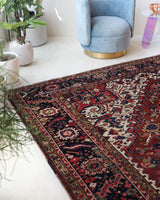 Antique Persian area rug in a living room setting, pile rug, vintage rug, portland, rug shop, bright colors, wild shaman, soft rug, bold color, Portland, Oregon, rug store, rug shop, local shop, antique rug, Persian rug, handmade rug, wool rug, distressed rug