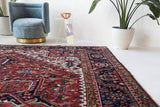 Antique Persian area rug in a living room setting, pile rug, vintage rug, portland, rug shop, bright colors, wild shaman, soft rug, bold color, Portland, Oregon, rug store, rug shop, local shop, antique rug, Persian rug, handmade rug, wool rug, distressed rug