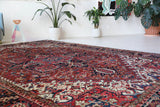 Antique Persian area rug in a living room setting, pile rug, vintage rug, portland, rug shop, bright colors, wild shaman, soft rug, bold color, Portland, Oregon, rug store, rug shop, local shop, antique rug, Persian rug, handmade rug, wool rug, distressed rug