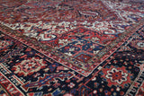 Antique Persian area rug in a living room setting, pile rug, vintage rug, portland, rug shop, bright colors, wild shaman, soft rug, bold color, Portland, Oregon, rug store, rug shop, local shop, antique rug, Persian rug, handmade rug, wool rug, distressed rug