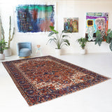 Antique Persian area rug in a living room setting, pile rug, vintage rug, portland, rug shop, bright colors, wild shaman, soft rug, bold color, Portland, Oregon, rug store, rug shop, local shop, antique rug, Persian rug, handmade rug, wool rug, distressed rug