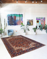 Antique Persian area rug in a living room setting, pile rug, vintage rug, portland, rug shop, bright colors, wild shaman, soft rug, bold color, Portland, Oregon, rug store, rug shop, local shop, antique rug, Persian rug, handmade rug, wool rug, distressed rug
