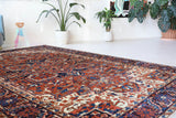 Antique Persian area rug in a living room setting, pile rug, vintage rug, portland, rug shop, bright colors, wild shaman, soft rug, bold color, Portland, Oregon, rug store, rug shop, local shop, antique rug, Persian rug, handmade rug, wool rug, distressed rug
