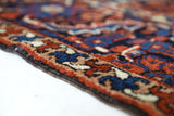 Antique Persian area rug in a living room setting, pile rug, vintage rug, portland, rug shop, bright colors, wild shaman, soft rug, bold color, Portland, Oregon, rug store, rug shop, local shop, antique rug, Persian rug, handmade rug, wool rug, distressed rug