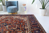 Antique Persian area rug in a living room setting, pile rug, vintage rug, portland, rug shop, bright colors, wild shaman, soft rug, bold color, Portland, Oregon, rug store, rug shop, local shop, antique rug, Persian rug, handmade rug, wool rug, distressed rug