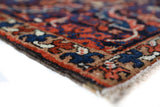 Antique Persian area rug in a living room setting, pile rug, vintage rug, portland, rug shop, bright colors, wild shaman, soft rug, bold color, Portland, Oregon, rug store, rug shop, local shop, antique rug, Persian rug, handmade rug, wool rug, distressed rug