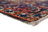 Antique Persian area rug in a living room setting, pile rug, vintage rug, portland, rug shop, bright colors, wild shaman, soft rug, bold color, Portland, Oregon, rug store, rug shop, local shop, antique rug, Persian rug, handmade rug, wool rug, distressed rug