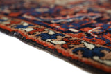 Antique Persian area rug in a living room setting, pile rug, vintage rug, portland, rug shop, bright colors, wild shaman, soft rug, bold color, Portland, Oregon, rug store, rug shop, local shop, antique rug, Persian rug, handmade rug, wool rug, distressed rug