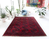 Antique Turkmen rug in a living room setting, pile rug, Turkish rug, vintage rug, portland, rug shop, bright colors, wild shaman, soft rug, bold color, Portland, Oregon, rug store, rug shop, local shop, antique rug