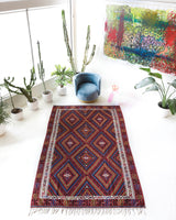 Vintage kilim rug in living room setting, bright colors, wild shaman, soft rug, bold color, Portland, Oregon, rug store, rug shop, local shop, vintage rug, modern kilim, warm colors, antique kilim rug