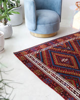 Vintage kilim rug in living room setting, bright colors, wild shaman, soft rug, bold color, Portland, Oregon, rug store, rug shop, local shop, vintage rug, modern kilim, warm colors, antique kilim rug