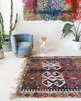 Vintage kilim rug in living room setting, old rug, antique rug, pastel colors, faded colors, Turkish rug, vintage rug, soft rug, Portland, Oregon, rug store, rug shop, local shop, earthy tones, earthy colors, warm colors