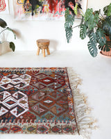 Vintage kilim rug in living room setting, old rug, antique rug, pastel colors, faded colors, Turkish rug, vintage rug, soft rug, Portland, Oregon, rug store, rug shop, local shop, earthy tones, earthy colors, warm colors