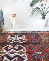 Vintage kilim rug in living room setting, old rug, antique rug, pastel colors, faded colors, Turkish rug, vintage rug, soft rug, Portland, Oregon, rug store, rug shop, local shop, earthy tones, earthy colors, warm colors