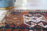 Vintage kilim rug in living room setting, old rug, antique rug, pastel colors, faded colors, Turkish rug, vintage rug, soft rug, Portland, Oregon, rug store, rug shop, local shop, earthy tones, earthy colors, warm colors