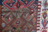 Vintage kilim rug in living room setting, old rug, antique rug, pastel colors, faded colors, Turkish rug, vintage rug, soft rug, Portland, Oregon, rug store, rug shop, local shop, earthy tones, earthy colors, warm colors