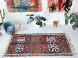 Vintage kilim rug in living room setting, old rug, antique rug, pastel colors, faded colors, Turkish rug, vintage rug, soft rug, Portland, Oregon, rug store, rug shop, local shop, earthy tones, earthy colors, warm colors