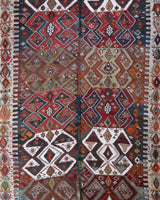 Vintage kilim rug in living room setting, old rug, antique rug, pastel colors, faded colors, Turkish rug, vintage rug, soft rug, Portland, Oregon, rug store, rug shop, local shop, earthy tones, earthy colors, warm colors