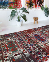 Vintage kilim rug in living room setting, old rug, antique rug, pastel colors, faded colors, Turkish rug, vintage rug, soft rug, Portland, Oregon, rug store, rug shop, local shop, earthy tones, earthy colors, warm colors