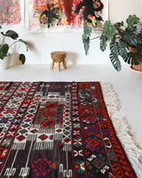 Vintage kilim rug in living room setting, old rug, antique rug, pastel colors, faded colors, Turkish rug, vintage rug, soft rug, Portland, Oregon, rug store, rug shop, local shop, earthy tones, earthy colors, warm colors