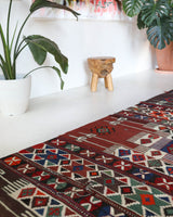 Vintage kilim rug in living room setting, old rug, antique rug, pastel colors, faded colors, Turkish rug, vintage rug, soft rug, Portland, Oregon, rug store, rug shop, local shop, earthy tones, earthy colors, warm colors
