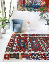 Vintage kilim rug in living room setting, bright colors, wild shaman, soft rug, bold color, Portland, Oregon, rug store, rug shop, local shop, vintage rug, modern kilim, warm colors, antique rug, antique kilim
