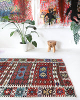 Vintage kilim rug in living room setting, bright colors, wild shaman, soft rug, bold color, Portland, Oregon, rug store, rug shop, local shop, vintage rug, modern kilim, warm colors, antique rug, antique kilim