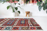 Vintage kilim rug in living room setting, bright colors, wild shaman, soft rug, bold color, Portland, Oregon, rug store, rug shop, local shop, vintage rug, modern kilim, warm colors, antique rug, antique kilim